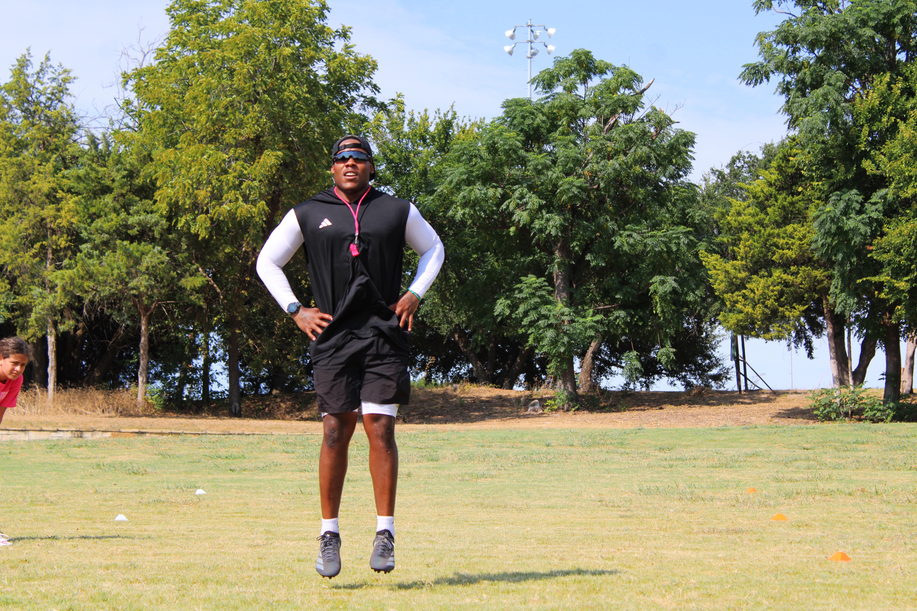 HG Performance coach demonstrating an explosive jump on the training field