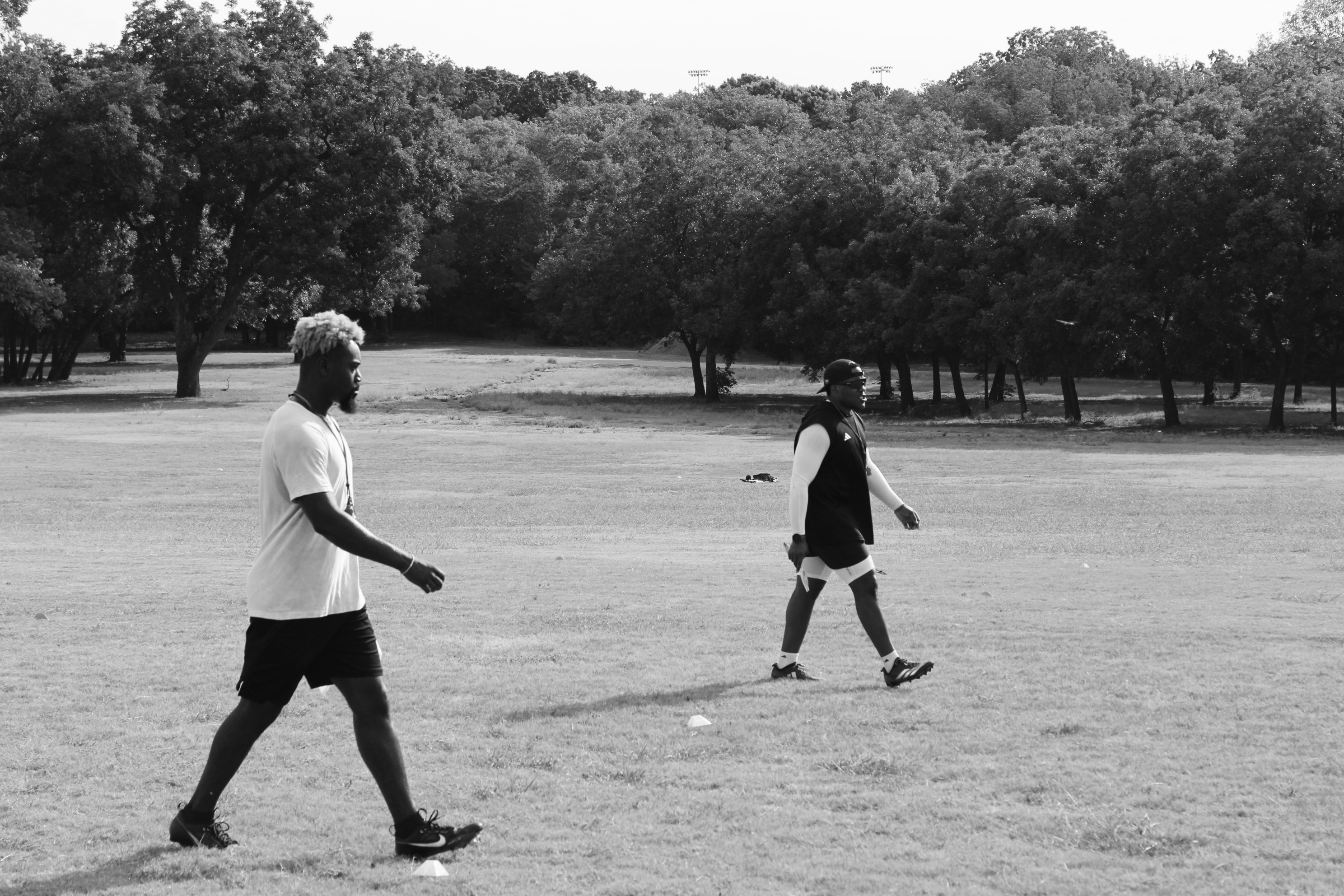 HG Performance coaches walking a field during a training session